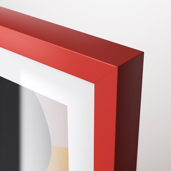 A close-up of a bright red frames sharp corner, showcasing its sleek, modern design and high-quality finish.