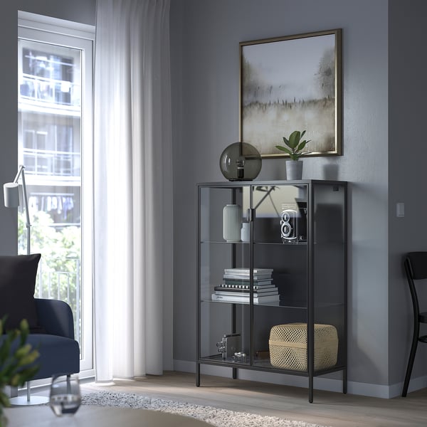 Modern living room with gray RUDSTA cabinet, large art, and blue chair.
