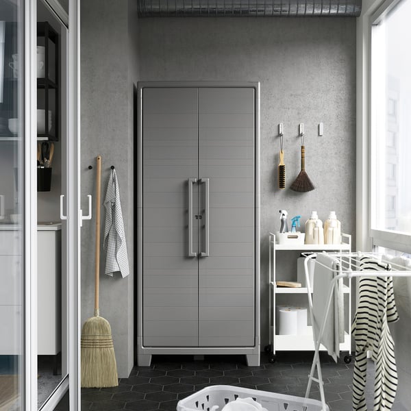 Gray RUNMARÖ cabinet in utility room with adjustable height and silver handles.
