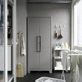 Gray RUNMARÖ cabinet in utility room with adjustable height and silver handles.