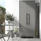 Gray RUNMARÖ cabinet outdoors with plastic dining set. Sleek, rectangular with two doors, ideal for storage.