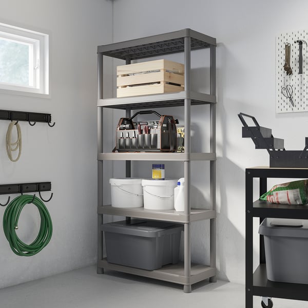 Gray 4-tier RUNMARÖ shelf with tools, near window & hose rack.