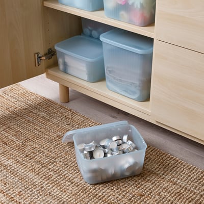 A light blue RYKTA storage box with lid, made of recycled plastic, rectangular-shaped with a slightly fluted design.