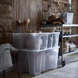 Clear plastic storage boxes on wheels, perfect for organizing and moving heavy items.