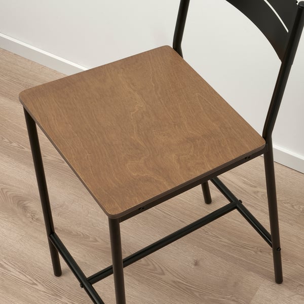 Modern bar stool with smooth wooden seat and sleek metal legs.