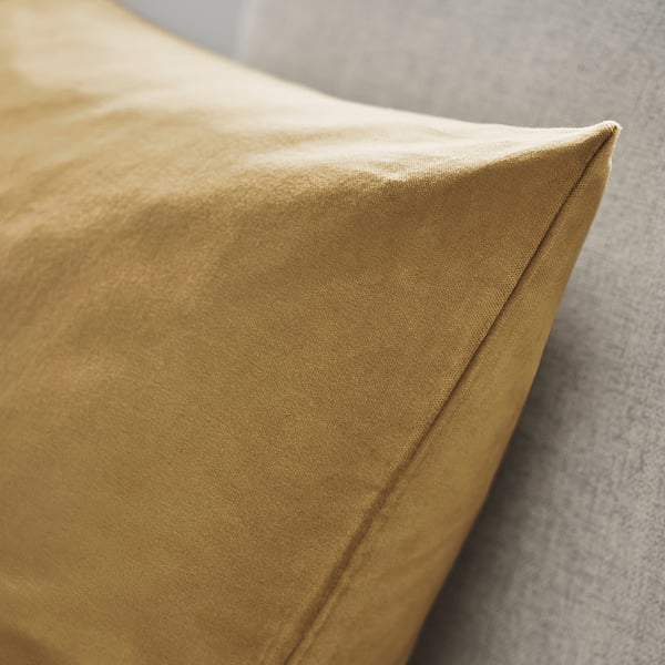 Close-up of mustard yellow cotton velvet cushion cover, showcasing its smooth texture and neat stitching.