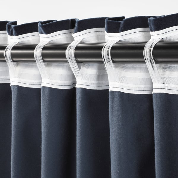 Blackout curtains with white tape details; folds create full pleats.