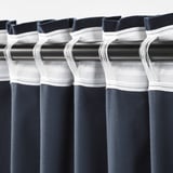 Blackout curtains with white tape details; folds create full pleats.