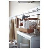 SAXBORGA glass jars with cork lids holding cotton swabs on a shelf. White, round, with decorative shark and elephant lids.