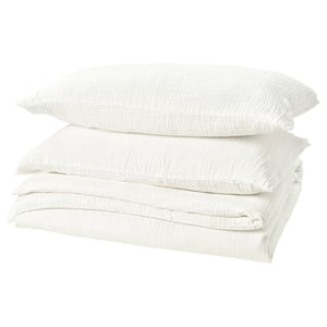 Stacked white bed linen set; includes duvet and pillow covers.