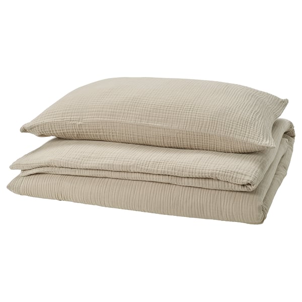 SCHERSMIN greige bedding set, folded. Made of soft muslin cotton, featuring a wavy texture and envelope closure pillows.