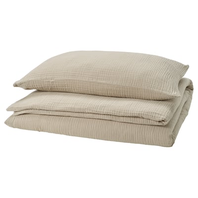 SCHERSMIN greige bedding set, folded. Made of soft muslin cotton, featuring a wavy texture and envelope closure pillows.