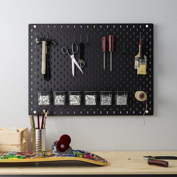 SKÅDIS black pegboard organizer with tools & containers on grey wall, compact yet spacious.
