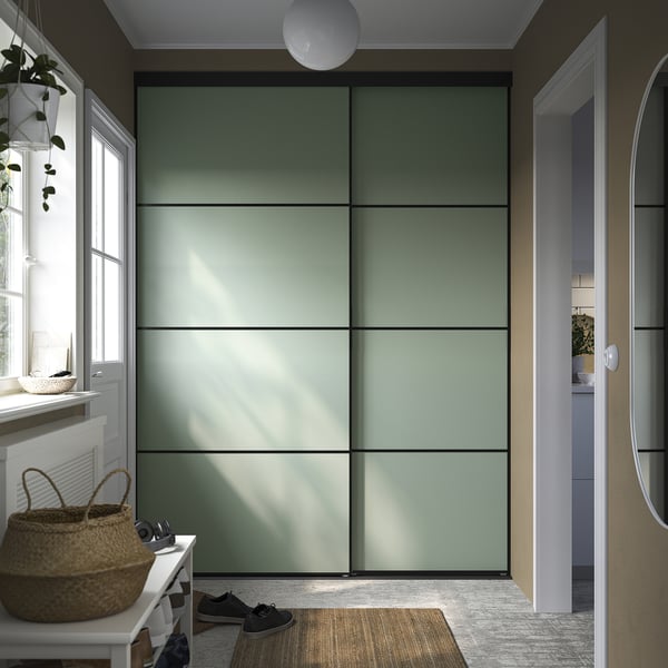 Modern hallway with green sliding closet door, white shoe rack, and wicker basket.