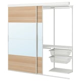A white SKYTTA wardrobe with glass and wooden panels, featuring mesh drawers and a clothes rail.