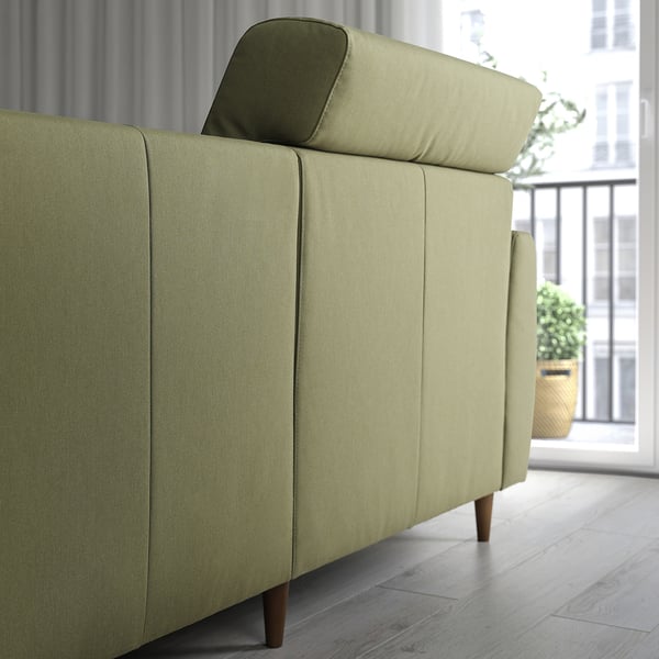 Modern green sofa with adjustable back cushions and extendable chaise. Perfect for comfort and relaxation.