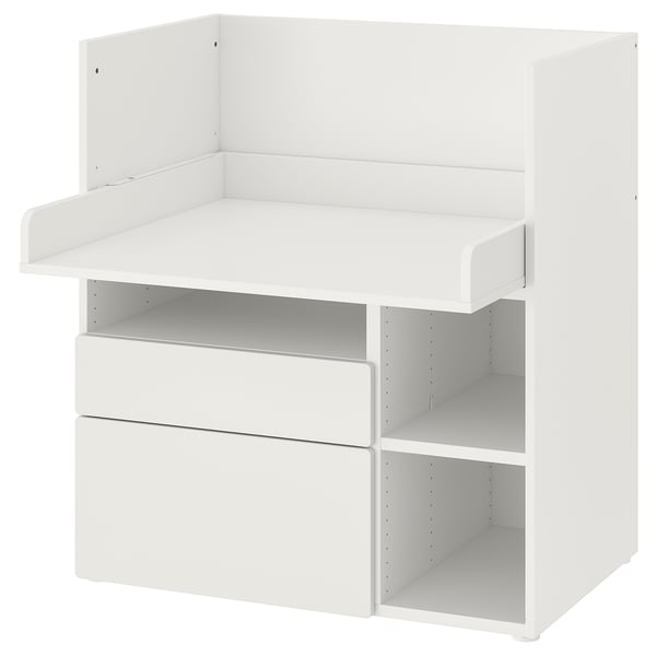 A white SMÅSTAD childrens desk and changing table combo by ikea. It drawers and shelves for storage.