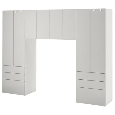 A white SMÅSTAD storage unit with cabinets and drawers, ideal for organizing clothes and items.