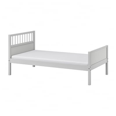 A white SMYGA wood bed with a simple, slatted headboard and footboard design.