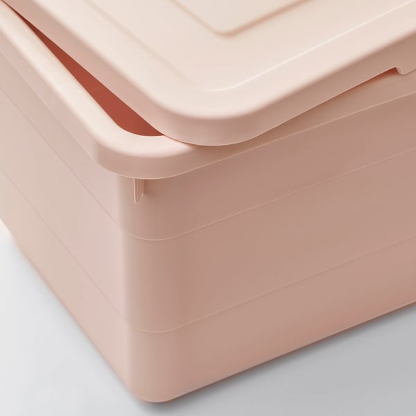 A close-up of light pink plastic storage box with lid, showcasing robust, smooth edges and secure latch mechanism.