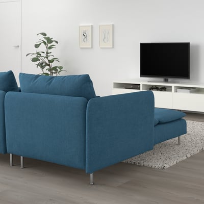 Modern living room with SÖDERHAMN blue sofa, floor plant, white tv console, and rug.