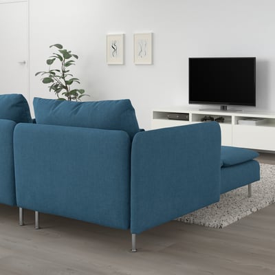 Modern living room with blue SÖDERHAMN sectional sofa, large tv, and plant on wooden floor.