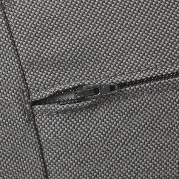 Close-up of durable, high-quality zipper on textured sofa cushion. Zipper is smoothly integrated into robust, water-repellent fabric.