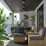 Modern patio: grey SOLLERÖN sectional, cushions, glass table, plants, sleek ceiling lights.