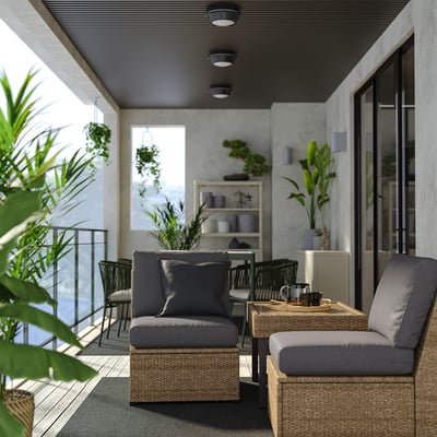 Modern patio: grey SOLLERÖN sectional, cushions, glass table, plants, sleek ceiling lights.