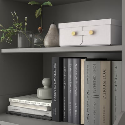 A SPINNROCK storage box in white with a textured surface and gold hardware, designed for organizing small items.