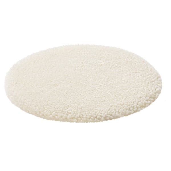Circular white sheepskin rug, plush and soft.