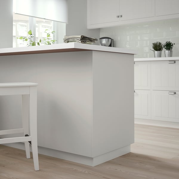 Modern white kitchen with grey island, clean, minimalist design.