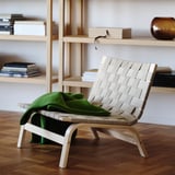 STOCKHOLM 2025 linen chair near bookshelf with blanket