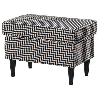 Black and white houndstooth patterned ottoman with tapered black legs.