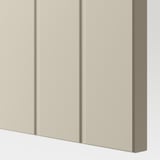 Beige cabinet front with three vertical panels, showcasing smooth texture and quality design.