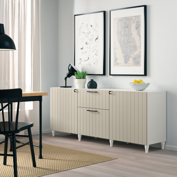 SUTTERVIKEN sideboard. Drawers & cabinets. Gray wall, black furniture, prints, plant.