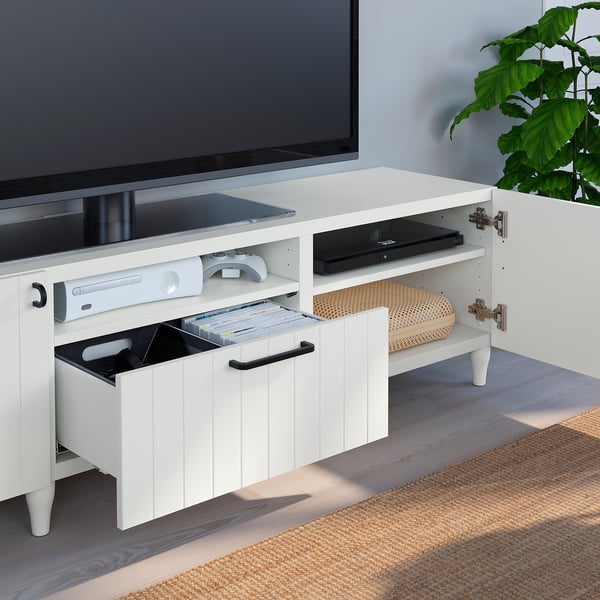 White tv stand with open drawers, storing games, and electronics. Perfect for neat storage, SUTTERVIKEN series.