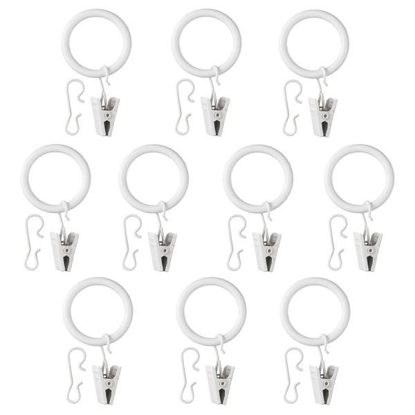 Multiple SYRLIG white curtain rings with hooks and clips arranged neatly.