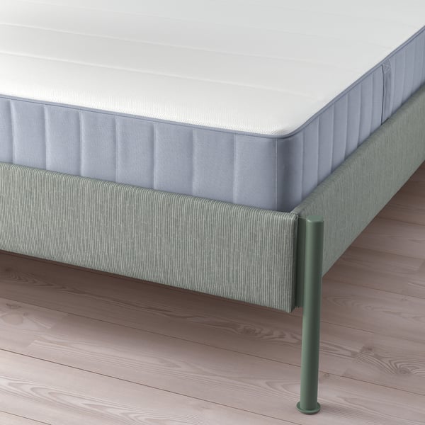 Modern bed frame with grey-green striped fabric, adjustable for mattress thickness, sturdy metal legs.
