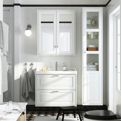 Modern white bathroom with TÄNNFORSEN vanity, tall cabinet, sleek sink, chrome fixtures. Drawers and glass shelves. .