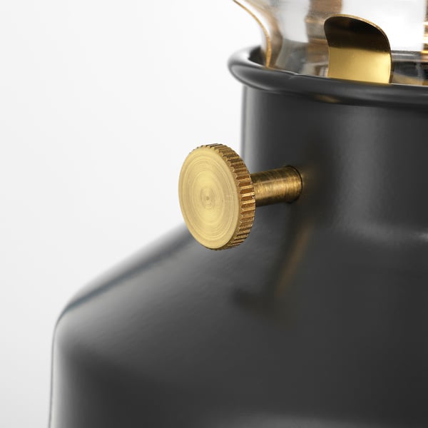 Modern lamp with black base and gold dimmer, elegant design.