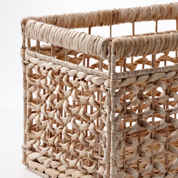 Handwoven basket with intricate patterns, made from natural water hyacinth. Sturdy and decorative, showcasing fine craftsmanship.