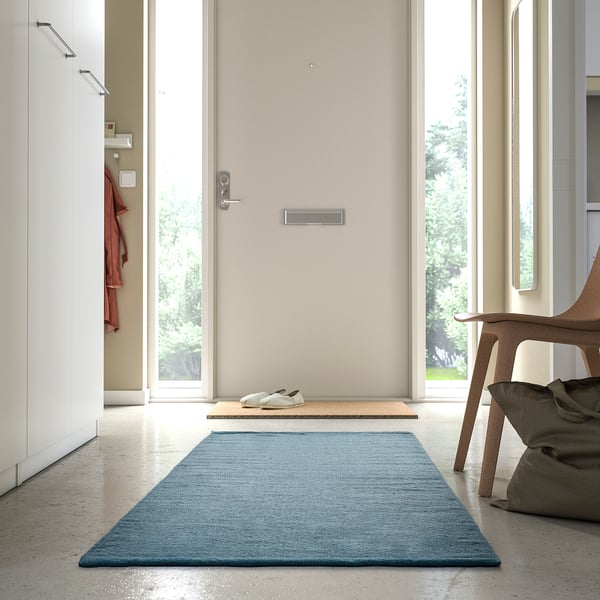 Modern hallway with a TIDTABELL rug, grey-blue, wool and cotton blend, rectangular, placed by entrance, smaller than shoe rack.