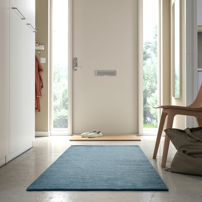 Modern hallway with a TIDTABELL rug, grey-blue, wool and cotton blend, rectangular, placed by entrance, smaller than shoe rack.