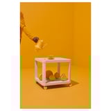 Pouring tea on cart with bowls and clock.