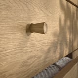Crafted wooden drawer handle by TONSTAD, showcasing high-quality design.