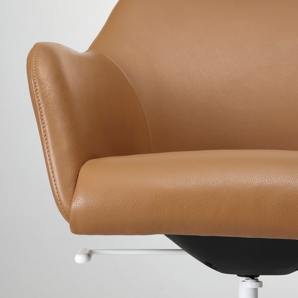 Close-up of a stylish, cushioned chair in light brown leather, showcasing its soft, padded backrest and armrest.
