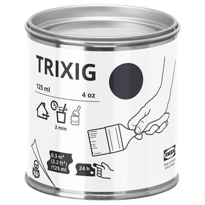 A can of ikea TRIXIG gray paint, cylindrical with a round lid, labeled with icons and text for use on wood and metal surfaces.
