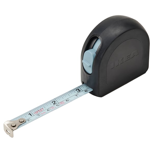Ikea tape measure, black with gray, retractable steel tape, labeled in both mm and inches, ergonomic design.