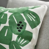 Green leafy cushion on white, thick fabric, boxed corners.